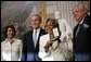 Rachel Robinson accepts the Congressional Gold Medal on behalf of her husband Jackie Robinson during a ceremony at the U.S. Capitol, Wednesday, March 2, 2005. Pictured, from left, are Congressional Minority Leader Nancy Pelosi, President George W. Bush, Rachel Robinson and Speaker of the House Dennis Hastert. White House photo by Eric Draper