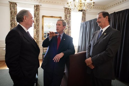 President George W. Bush talks with Canadian Prime Minister Paul Martin, left, and Mexican President Vicente Fox, right, during their March 23, 2005, trilateral meeting at Baylor University in Waco, Texas. White House photo by Eric Draper White House photo by Eric Draper