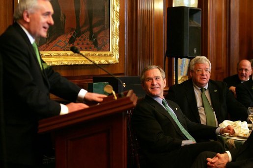 President George W. Bush and Speaker of the House Dennis Hastert, right, listen to remarks by Irish Prime Minister Bertie Ahern during a St. Patrick's Day Luncheon at the U.S. Capitol Thursday, March 17, 2005. White House photo by Krisanne Johnson