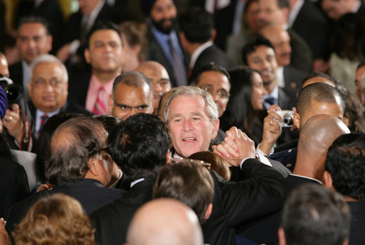 President George W. Bush reaches into the audience to shake hands after signing H.R. 7081, The United States-India Nuclear Cooperation Approval and Nonproliferation Enhancement Act, Wednesday, Oct. 8, 2008, in the East Room at the White House. White House photo by Chris Greenberg