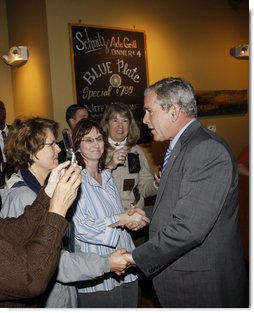 President George W. Bush greets diners Wednesday, Oct. 15, 2008, at the Schnitz Ada Deli and Grill in Ada, Michigan. The President met with business owners from the Grand Rapids area over lunch at the deli to talk about the economy. White House photo by Eric Draper