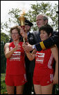 President George W. Bush and Police Chief Russ Laine of Algonquin, Ill., stand with torch runners Karen Dickerson of Springfield, Va., left, and Qiao Meili of Shanghai, China, during a Special Olympics Global Law Enforcement Torch Run Ceremony Thursday, July 26, 2007, in the Rose Garden. White House photo by Eric Draper