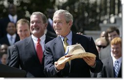 President George W. Bush shows the signatured cowboy hat presented to him by Indianapolis Colts team owner and CEO Jim Irsay, left, during the White House ceremony to honor the Super Bowl champions Monday, April 23, 2007. White House photo by Eric Draper