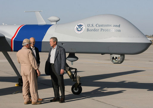 Standing next to a Predator Drone, Maj. Gen. Mike Kostelnik speaks with President George W. Bush and Secretary Michael Chertoff of Homeland Security during their tour Monday, April 9, 2007, of the U.S.-Mexico border in Yuma, Ariz. Said the President, "It's the most sophisticated technology we have, and it's down here on the border to help Border Patrol agents do their job." White House photo by Eric Draper