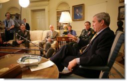 President George W. Bush delivers a statement on the War in Iraq during a visit Monday, April 23, 2007, by Gen. David Petraeus, Commander of the Multinational Force-Iraq, to the White House. Said the President, "I will strongly reject an artificial timetable withdrawal and/or Washington politicians trying to tell those who wear the uniform how to do their job." With them is Gen. Peter Pace, Chairman of the Joint Chiefs of Staff, left, and Gordon England, Deputy Secretary of Defense.  White House photo by Eric Draper