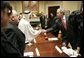 President George W. Bush exchanges handshakes with Mr. Mohammed Jaber during a visit at the White House Wednesday, Jan. 18, 2006, with victims of Saddam Hussein. Mr. Jaber is a former Iraqi journalist who was jailed for writing a story that raised questions about how oil money was being spent. White House photo by Eric Draper