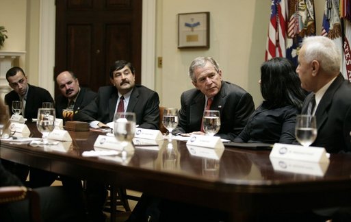 President George W. Bush listens to Gelawish Merani as she sits next to her father, Mikael Doski, during a visit to the White House Wednesday, Jan. 18, 2006, by victims of Saddam Hussein. The father and daughter, separated in 1977 while living under Hussein's rule, were reunited after 16 years apart. White House photo by Eric Draper