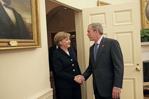 President George W. Bush welcomes German Chancellor Angela Merkel to the Oval Office Friday, Jan. 13, 2006. It is Chancellor Merkel's first visit to the White House. White House photo by Eric Draper