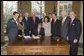 Accompanied by Laura Bush and legislators, President George W. Bush signs H.R. 3402, The Violence Against Women and Department of Justice Reauthorization Act of 2005, during a ceremony in the Oval Office Thursday, Jan. 5, 2005. The bill is a comprehensive package that reauthorizes Department of Justice programs to combat domestic violence, dating violence, sexual assault, and stalking. White House photo by Paul Morse