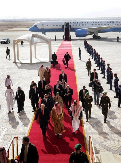 Followed by a group of Saudi and US delegates, Vice President Dick Cheney walks down a red carpet with Prince Saud al-Faisal bin Abdulaziz, Saudi Minister of Foreign Affairs, upon arrival to King Khalid International Airport in Saudi Arabia, Tuesday January 17, 2006. White House photo by David Bohrer