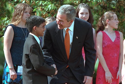 President George W. Bush greets one of the award winners during the 2002 President's Environmental Youth Awards Ceremony in The Rose Garden April 18. "I want to thank so much the award winners for turning idealism into action; for taking a great spirit and love for our country and doing something about that spirit and love for our country." White House photo by Paul Morse.