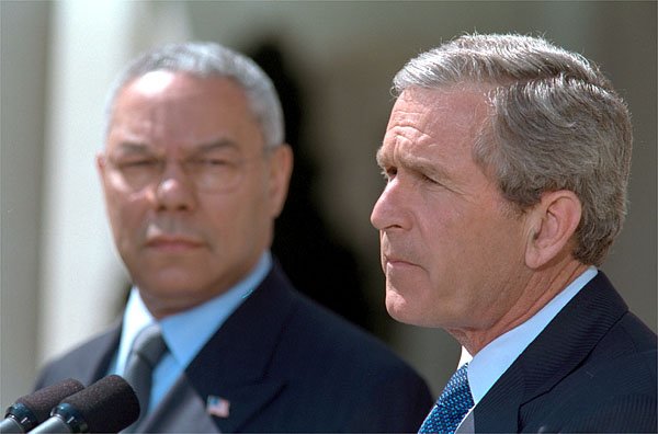 President George W. Bush outlines his plan to resolve the conflict in the Middle East as Secretary of State Colin Powell stands by his side in the Rose Garden Thursday, April 4. White House photo by Paul Morse.
