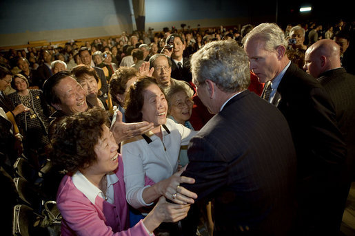 Audience members greet and hug President George W. Bush after his talk about the Medicare prescription drug benefits at the Richard J. Ernst Community Center at Northern Virginia Community College in Annandale, Va., Wednesday, April 12, 2006. President Bush urged senior citizens to participate in the new Medicare program to reduce their drug costs. White House photo by Kimberlee Hewitt