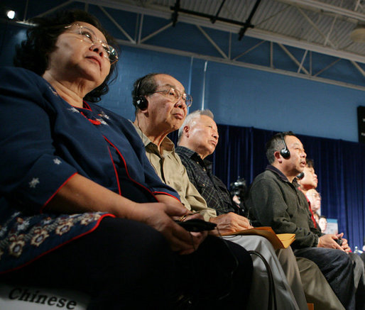 Audience members, some using headphones to hear a translation, listen to President George W. Bush talking to senior citizens at a Conversation on the Medicare Prescription Drug Benefit, Wednesday, April 12, 2006 at the Richard J. Ernst Community Center at Northern Virginia Community College in Annandale, Va. President Bush urged senior citizens to participate in the new Medicare drug benefit program to help reduce their drug costs. White House photo by Kimberlee Hewitt