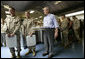President George W. Bush stands in the chow line with Marines during his visit to Marine Corps Air Ground Combat Center in Twentynine Palms, California, Sunday, April 23, 2006. White House photo by Eric Draper