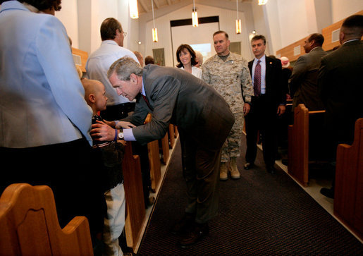 President George W. Bush greets parishioners at the end of a church service at the Marine Corps Air Ground Combat Center in Twentynine Palms, California, Sunday, April 23, 2006. White House photo by Eric Draper
