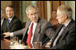 President George W. Bush places his hands on the arm of U.S. Senate Majority leader Senator Bill Frist, R-Tenn., left, and U.S. Senate Democratic leader Senator Harry Reid, D-Nev., right, at the conclusion of a meeting with legislators Tuesday, April 25, 2006 at the White House to discuss immigration reform. President Bush thanked both Republican and Democratic members of the Senate for their hard work to get a comprehensive immigration bill out of the U.S. Senate and hopefully to his desk before the end of this year. White House photo by Eric Draper