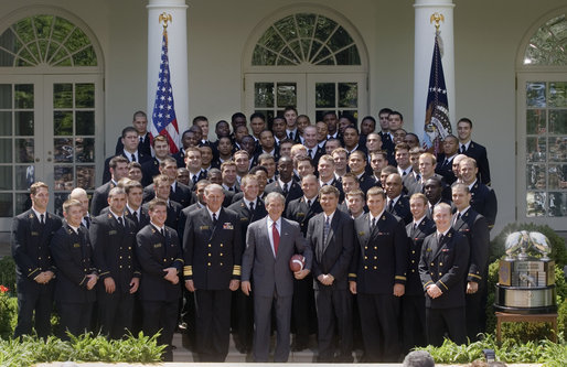 President George W. Bush poses with the United States Naval Academy football team during the presentation of the Commander-in-Chief Trophy in the Rose Lawn April 25, 2006. "Seniors on this team have lead one of the most dramatic turn-arounds in college football history," said the President. "Navy has won 26 games in the past three seasons after winning just three games during the previous three years. The seniors are the sixth class in Academy history to have beaten Army all four years." White House photo by Kimberlee Hewitt