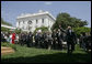 President George W. Bush waves to the United States Naval Academy football team after the presentation of the Commander-in-Chief Trophy in the Rose Lawn April 25, 2006. White House photo by Paul Morse