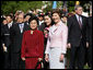 Mrs. Laura Bush stands with Liu Yongqing, the wife of Chinese President Hu Jintao, during the South Lawn Arrival Ceremony, Thursday, April 20, 2006. White House photo by Shealah Craighead
