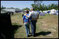 President George W. Bush walks with Hands On Network Disaster Response Coordinator Erika Putinsky during a tour of their base camp in Biloxi, Mississippi, Thursday, April 27, 2006. White House photo by Eric Draper