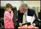 President George W. Bush spends a few moments with Kim Han-Mee in the Oval Office, the daughter of North Korean defectors, during a meeting April 28, 2006 with North Korean defectors and family members of Japanese citizens who were abducted by North Korea. White House photo by Paul Morse