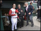 President George W. Bush stands with Reds catcher Jason LaRue and team CEO Bob Castellini during the opening game between the Cincinnati Reds and the Chicago Cubs in Cincinnati, Ohio, Monday, April 3, 2006. White House photo by Eric Draper