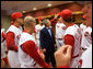 President George W. Bush talks with Reds outfielder and fellow Texan Adam Dunn during a visit with the team before throwing out the first pitch of the opening game between the Cincinnati Reds and the Chicago Cubs in Cincinnati, Ohio, Monday, April 3, 2006. White House photo by Eric Draper