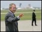 President George W. Bush waves as he walks across the tarmac to Air Force One before departing TSTC Airport in Waco, Texas, Wednesday, Aug. 11, 2004. White House photo by Eric Draper.