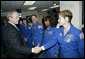 President George W. Bush greets shuttle astronauts from right, Peggy Whitson, Stephanie Wilson, and John Grunsfeld, and Ellen Ochoa at NASA headquarters in Washington, D.C., Wednesday, Jan. 14, 2004. The President committed the United States to a long-term human and robotic program to explore the solar system, starting with a return to the Moon that will ultimately enable future exploration of Mars and other destinations. White House photo by Eric Draper