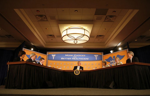 President George W. Bush joins U.S. Secretary of Health & Human Services, Mike Leavitt, left, and Minnesota health care professionals in a panel discussion Tuesday, Aug. 22, 2006, at the Minneapolis Marriott Southwest in Minnetonka, Minn., to offer perspectives on efforts to enhance health care transparency and move towards a value-based health care competition. White House photo by Paul Morse