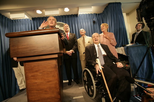 Sharing the stage with several White House Press Secretaries, President George W. Bush jokes with reporters in the James S. Brady Press Briefing Room Wednesday, August 2, 2006. It was the last press briefing before the room undergoes extensive renovations. Pictured at the President’s right is Press Secretary James S. Brady, who was wounded during an assassination attempt on President Reagan. The room is named in his honor. White House photo by Eric Draper