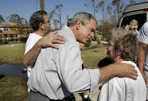 President George W. Bush comforts residents during a walking tour of neighborhoods damaged by Hurricane Ivan in Pensacola, Florida, Sunday, Sept. 19, 2004. White House photo by Eric Draper