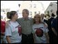 President George W. Bush talks with residents of Millvale, Pa. at the Millvale Fire Department during a visit to the area recently flooded by Tropical Depression Ivan in Allegheny County, Pa., Wednesday, Sept. 22, 2004. White House photo by Eric Draper.