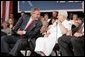 President George W. Bush laughs with senior Wanda Blackmore during a conversation on Medicare-approved prescription drug discount cards in Liberty, Mo., June 14, 2004. White House photo by Paul Morse