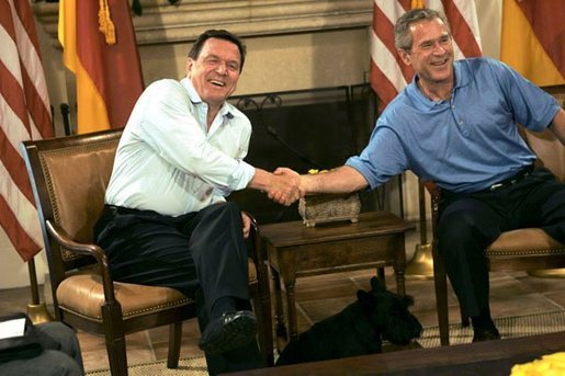 President George W. Bush and German Chancellor Gerhard Schroeder shake hands during their bilateral meeting at the G-8 Summit in Sea Island, Ga., Tuesday, June 8, 2004. Barney, is seen in foreground. White House photo by Eric Draper