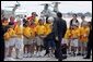 German Chancellor Gerhard Schroeder kicks a soccer ball with students during his arrival for the G8 Summit at Hunter Army Airfield in Savannah, Ga., June 8, 2004. White House photo by Paul Morse