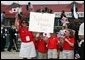 Children cheer the arrival of Japanese Prime Minister Junichiro Koizumi at Hunter Army Airfield in Savannah, Ga., June 8, 2004. White House photo by Paul Morse