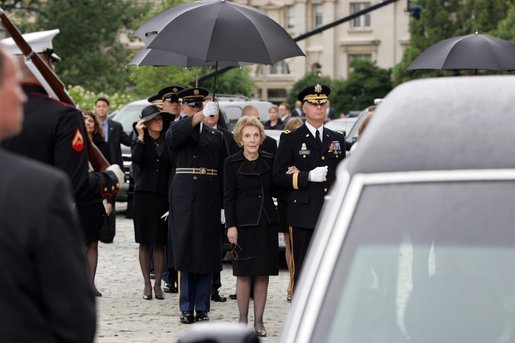 Former First Lady Nancy Reagan watches the casket of former President Ronald Reagan being loaded into a hearse at the funeral service at the National Cathedral in Washington, DC on June 11, 2004. White House photo by Paul Morse.