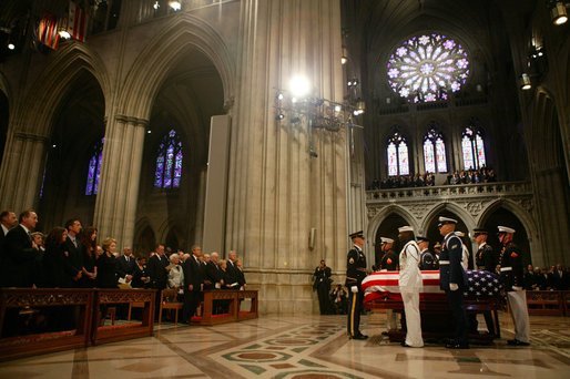The casket of former President Ronald Reagan is surrounded by military service pall bearers at the funeral service at the National Cathedral in Washington, DC on June 11, 2004. White House photo by Paul Morse.