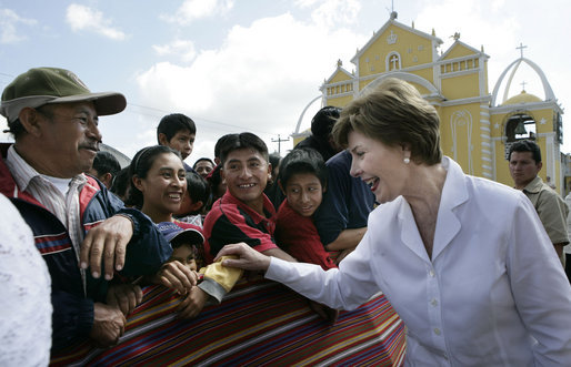 Mrs. Laura Bush reaches out to a small child during a visit Monday, March 12, 2007, to the Town Square in Santa Cruz Balanya, Guatemala. White House photo by Eric Draper