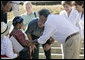 President George W. Bush, Mrs. Laura Bush, Guatemalan President Oscar Berger, center, and his wife Wendy Widmann de Berger, far right, talk with children from the Carlos Emilio Leonardo School upon their arrival Monday, March 12, 2007, in Santa Cruz Balanya, Guatemala. The couple visited a medical readiness and training exercise at the school. White House photo by Eric Draper