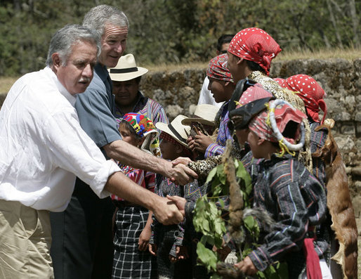 President George W. Bush and President Oscar Berger of Guatemala meet members of the Patzun Dance Group after a performance Monday, March 12, 2007, during a visit to Iximche, Guatemala. White House photo by Eric Draper