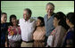 President George W. Bush smiles as he and Guatemalan President Oscar Berger join villagers in Santa Cruz Balanya, Guatemala, Monday, March 12, 2007, for a photo while visiting the Carlos Emilio Leonardo School in the village. White House photo by Eric Draper