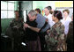 President George W. Bush gets a hug from a woman Monday, March 12, 2007, during a visit to a medical readiness and training exercise site at the Carlos Emilio Leonardo School in Santa Cruz Balanya, Guatemala. Also pictured is Guatemalan President Oscar Berger, center, and Mrs. Laura Bush. White House photo by Paul Morse