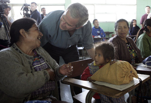President George W. Bush talks with a woman and young girl Monday, March 12, 2007, during his visit to the Carlos Emilio Leonard School in Santa Cruz Balanya, Guatemala. White House photo by Eric Draper