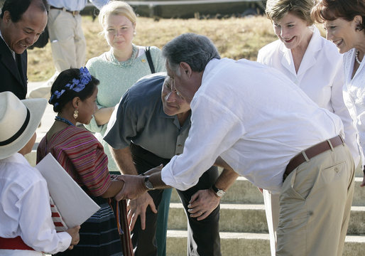 President George W. Bush, Mrs. Laura Bush, Guatemalan President Oscar Berger, center, and his wife Wendy Widmann de Berger, far right, talk with children from the Carlos Emilio Leonardo School upon their arrival Monday, March 12, 2007, in Santa Cruz Balanya, Guatemala. The couple visited a medical readiness and training exercise at the school. White House photo by Eric Draper