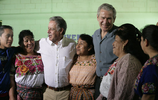President George W. Bush smiles as he and Guatemalan President Oscar Berger join villagers in Santa Cruz Balanya, Guatemala, Monday, March 12, 2007, for a photo while visiting the Carlos Emilio Leonardo School in the village. White House photo by Eric Draper