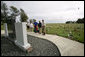 Mrs. Laura Bush visits the Battle of Midway Memorial on the parade grounds of Midway Island Thursday, March 1, 2007. Midway Atoll was the site of the World War II battle June 4, 1942. The U.S. Navy defeated a Japanese attack against Midway Islands, marking a turning point in the war in the pacific theater. Interior Secretary Dirk Kempthorne is pictured wearing a blue shirt and is standing next to Mrs. Bush. White House photo by Shealah Craighead