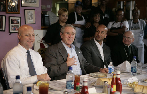 President George W. Bush is joined by New Orleans Mayor Ray Nagin, Louisiana Lt. Gov. Mitch Landrieu, left, and New Orleans Archbishop Alfred Hughes, right, Thursday, March 1, 2007 in New Orleans, during a luncheon with elected officials and community leaders on the recovery progress of their Gulf Coast region. White House photo by Eric Draper